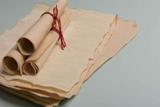 Raven feather, inkwell and old yellowed paper on red background. Copy space. Old letter.