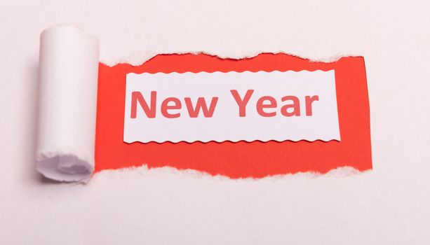 White torn paper with New Year text with red background color. Hidden message. Secret. Copy space