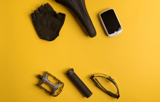 Bicycle, Cycling accessories on the yellow background. view from above
