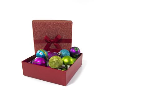 gift boxes in red with christmas balls in red silver gold blue and other colors isolated on white background