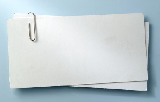 white sheet of paper for notes and paper clip