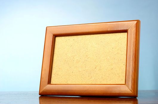 wooden photo frame on a blue background