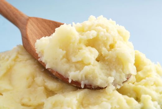 mashed potatoes in a brown wooden spoon