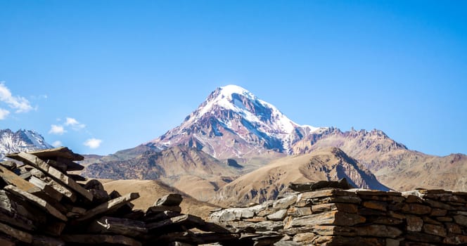 landscape high rocky mountains of the Caucasus in Georgia on a background of blue sky and clouds