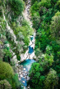 landscape view from above on a mountain canyon gorge with a river and green forest in Georgia in autumn afternoon