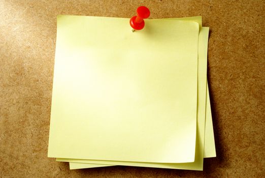 yellow sheet of paper for notes and pushpin