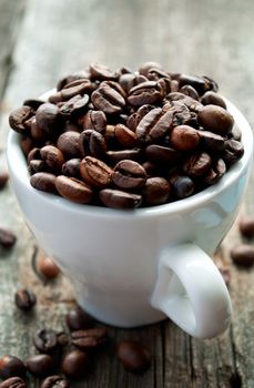 roasted coffee beans in a cup on the table