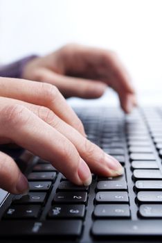 female hands writing on laptop, close-up shot