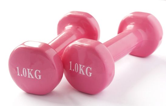 Two pink dumbbells on a white background