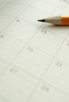 home calendar with dates and yellow sharpened pencil