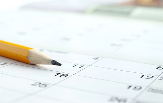 calendar and a pencil to mark the desired date