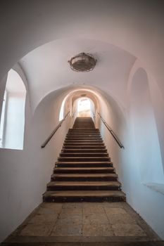 An ancient staircase inside the tunnel leads up. There are stone steps.