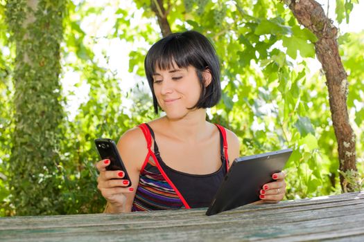 casual woman working with a tablet pc, outdoor