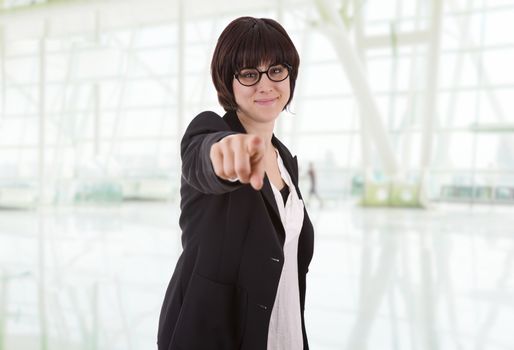 young happy beautiful business woman pointing, at the office