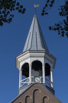 Historic wooden steeple of the church in the center of the village Midsland on the island of Terschelling in the northern Netherlands 
