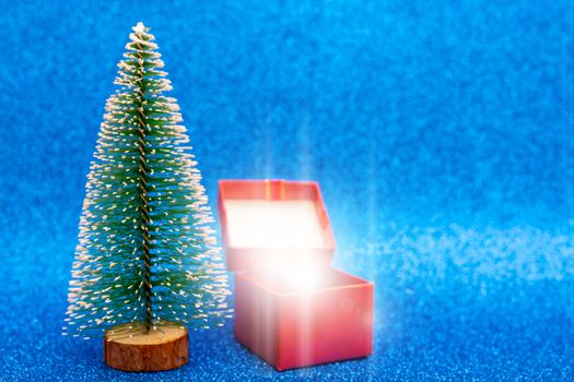 Christmas tree and gift box. Festive christmas background.