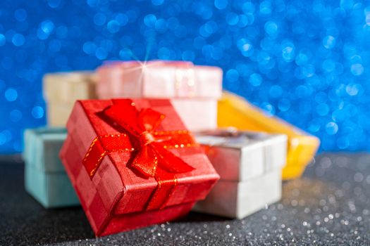 Cristmas presents. Multi-colored boxes with gifts.