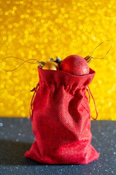 Christmas golden background. Red gift bag and Christmas toys.