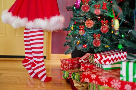 In images Christmas characters snow maiden. Girl in a Christmas costume decorates the Christmas tree