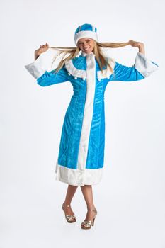 Young beautiful girl in a carnival clothing on a studio background