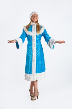 Young beautiful girl in a carnival clothing on a studio background