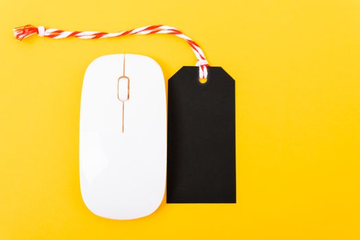 Online shopping Blank black tag on white mouse with yellow background