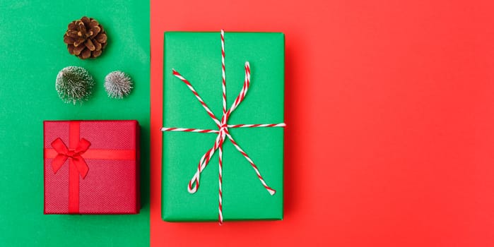 New Year, Christmas Xmas holiday composition, Top view with gift box, clews of rope, green fir tree branch on red and green background with copy space