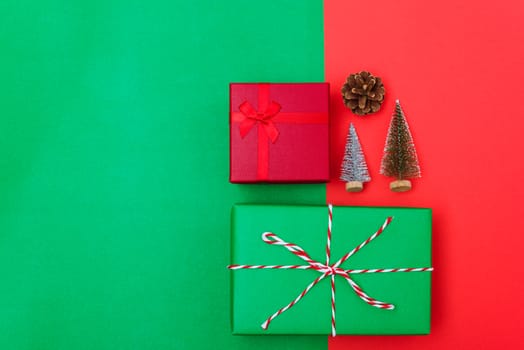 New Year, Christmas Xmas holiday composition, Top view with gift box, clews of rope, green fir tree branch on red and green background with copy space