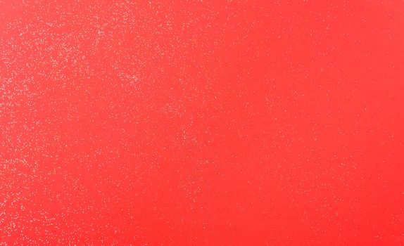 Shiny particles glitter on red background Christmas decorative with copy space