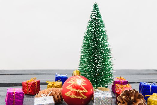 Christmas composition decorations, minimal green fir tree branches with snow and gift boxs on white background. Merry Christmas concept. Copy space for text