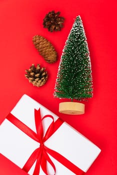 Happy New Year and Christmas 2020 day, top view Xmas white gift boxes & fir tree on red background with copy space for your text