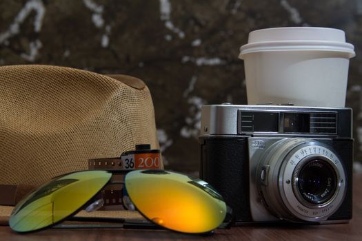 variety of essential items for hipsters. Lenses, camera, hat and coffee