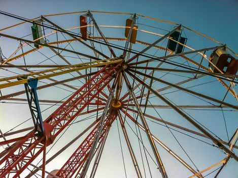 Multicolored ferris wheel over blue sky on a summer afternoon. Mexico City