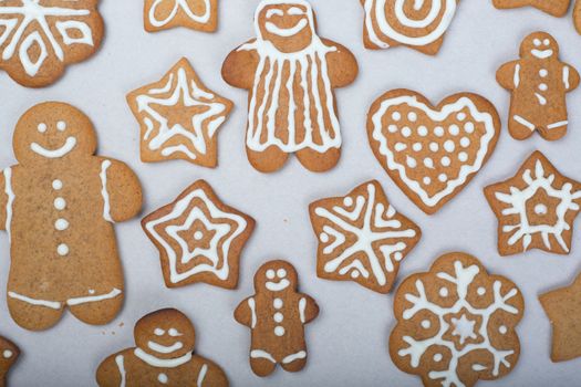 Gingerbread men stars and snowflakes glazed cookies Christmas background