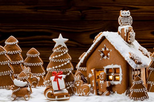 Gingerbread house christmas fir trees and gift cookies winter holiday celebration concept