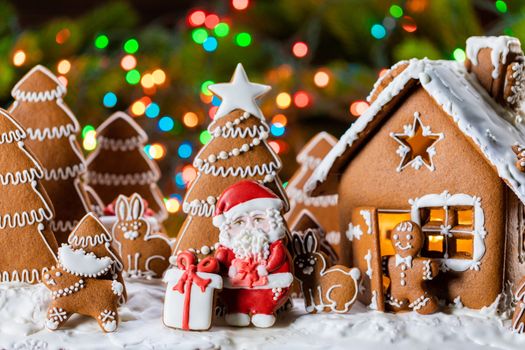 Gingerbread house christmas fir trees Santa Claus and gift cookies winter holiday celebration concept
