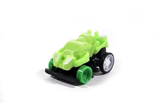 The green toy car is a collection put on a white background.