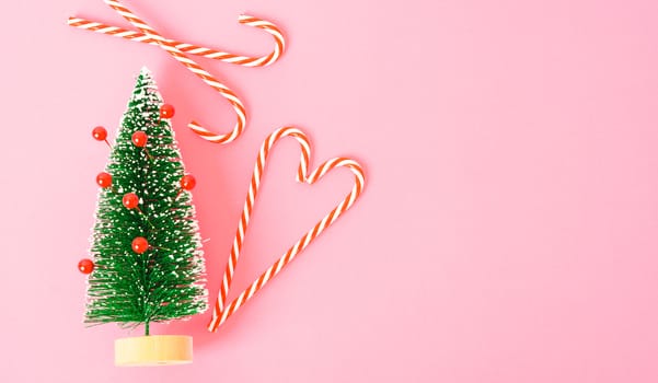 Happy New Year and Christmas day, top view flat lay composition decoration tree fir branch on pink background with copy space for your text