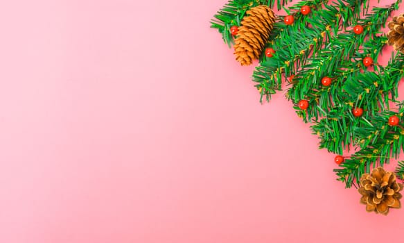 Happy New Year and Christmas day, top view flat lay composition decoration tree fir branch on pink background with copy space for your text