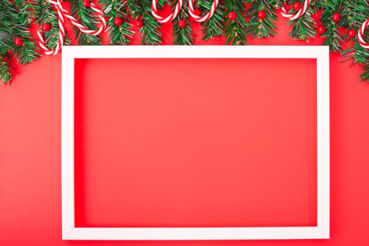 Happy New Year and Christmas day, top view flat lay composition decoration tree fir and photo frame on red background with copy space for your text