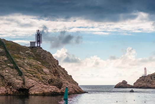 Entrance to Bukh, covered with rocks beautiful seascape on a cloudy day, dramatic sky