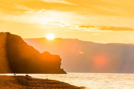 Bright sun, beautiful rocks and the sea, beautiful scenery at dawn