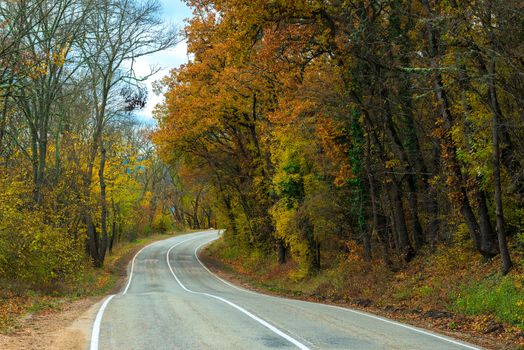 Car winding road in the mountains on an autumn afternoon