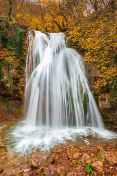 Vertical photo of the beautiful waterfall Jur-Jur in the Crimea, autumn landscape