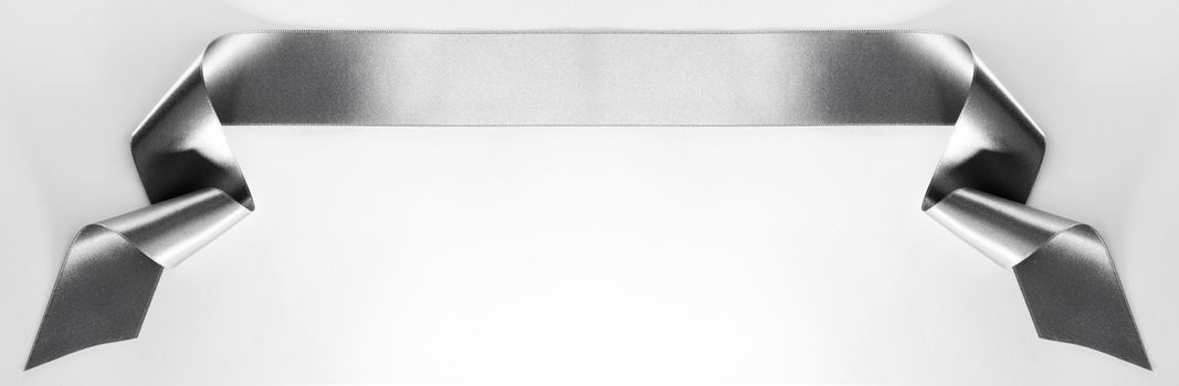 Silver satin ribbon banner isolated on white background