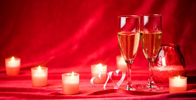 Valentines day background with champagne glasses candles and hearts