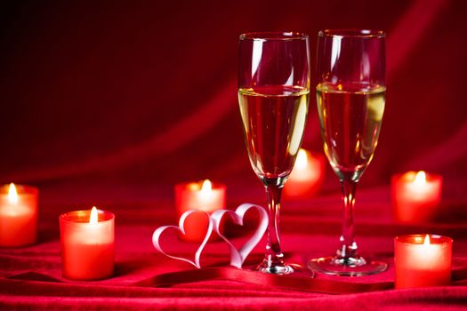 Valentines day background with champagne glasses candles and hearts