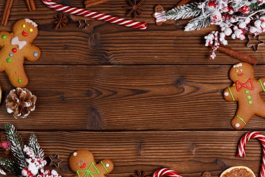 Christmas flat lay background with traditional gingerbread cookies dried orange cinnamon on wood , copy space for text