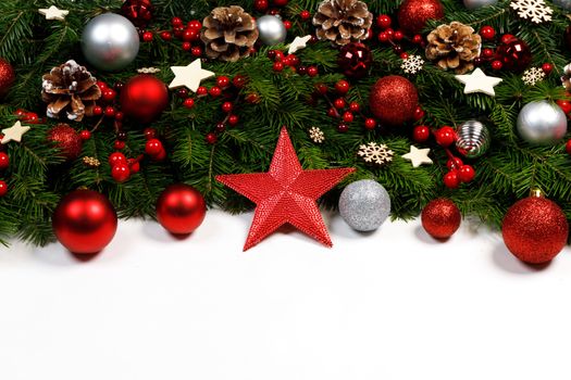 Christmas New year decoration frame isolated on white , fir tree branches , red baubles and pine cones , wooden decor , red berries , copy space for text