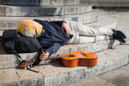 a Walking player sleeping lying on the steps